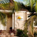 Front with Palm Trees banner